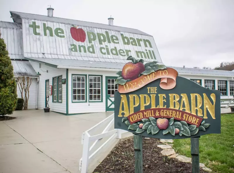 exterior of the apple barn and cider mill with a sign