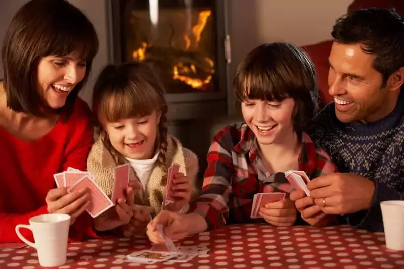 family playing cards by a fire in a Gatlinburg TN cabin