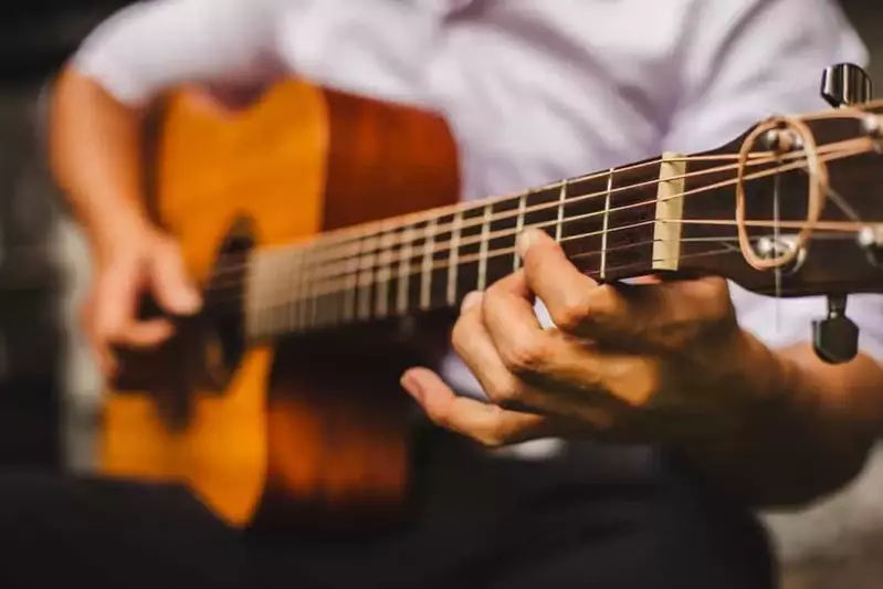 man strumming guitar