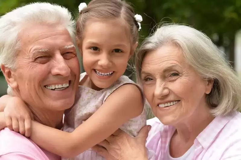 Smiling grandparents with granddaughter at a 5 bedroom Gatlinburg cabin