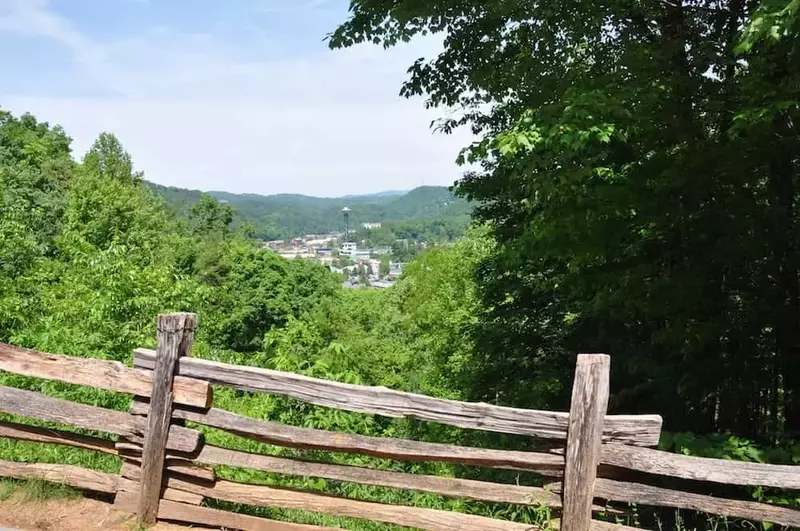 view of downtown Gatlinburg with split rail fence