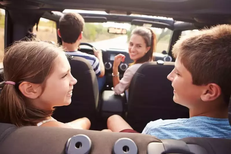 family in open top car driving in the Smoky Mountains