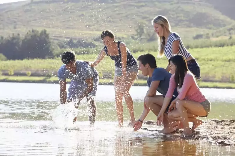 group of friends playing in a river near Gatlinburg TN