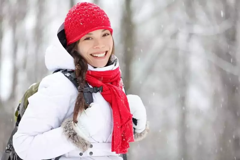 a young woman with backpack hiking in the Smokies in the snow