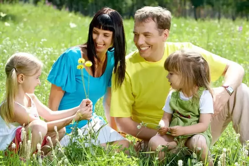 Family enjoying spring flowers in a Smoky Mountain meadow