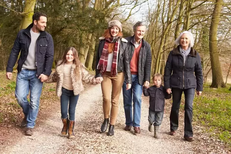 Family walking on a quiet road in the woods