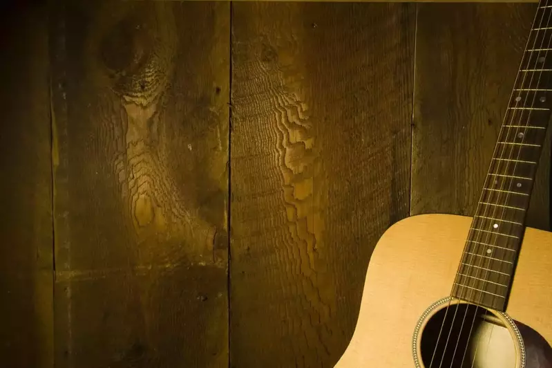 Guitar leaning against a wood plank wall