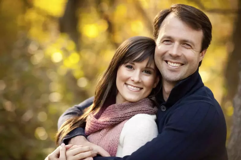 Smiling happy couple standing in the woods in the Smoky Mountains