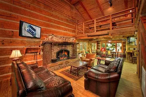 living room with stone fireplace in Gatlinburg log cabin