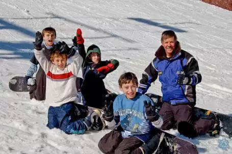 Man and children snowboarding at Ober Gatlinburg