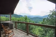 view from deck of Honey Bear cabin with hot tub and rocking chairs