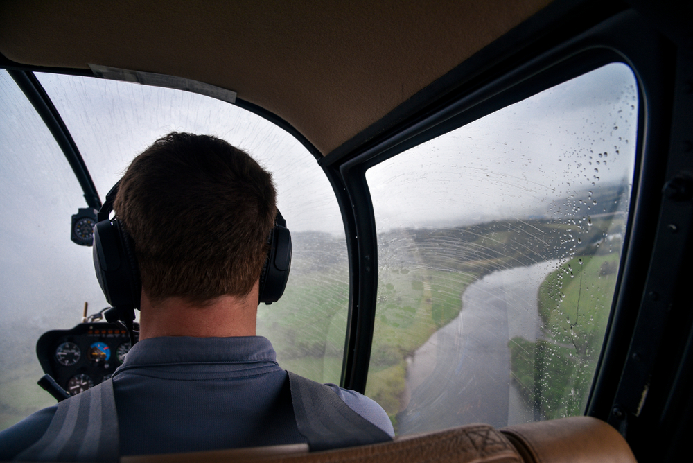 pilot flying helicopter over Smoky Mountain river