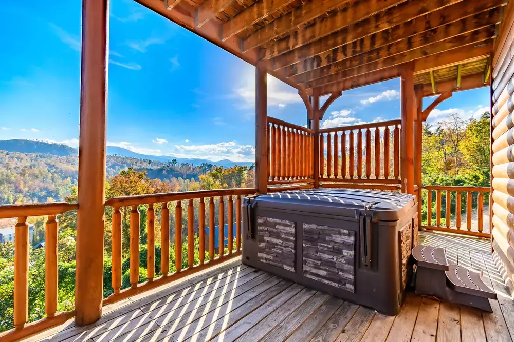 hot tub with fall mountain view at Big Sky cabin