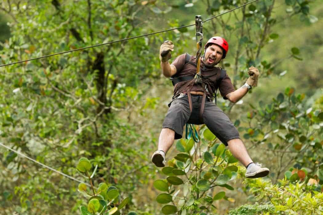 Man ziplining through the woods