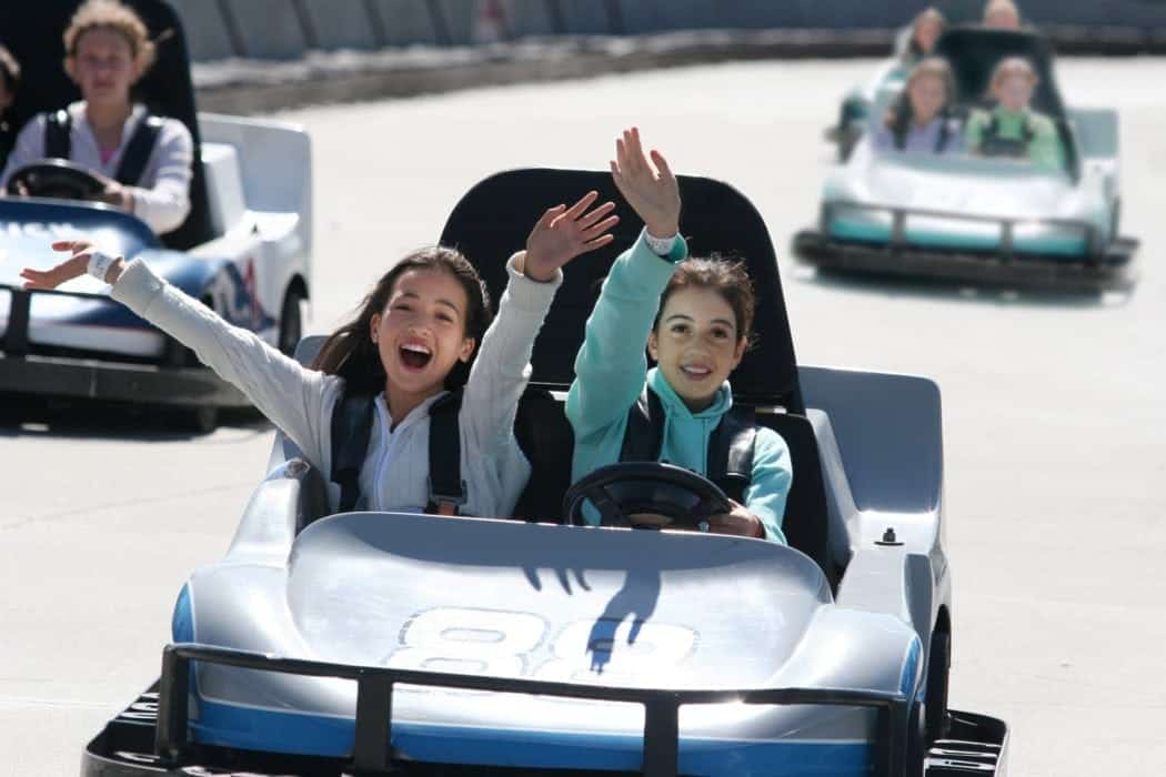 girls waving while driving a Go Kart in Pigeon Forge, TN