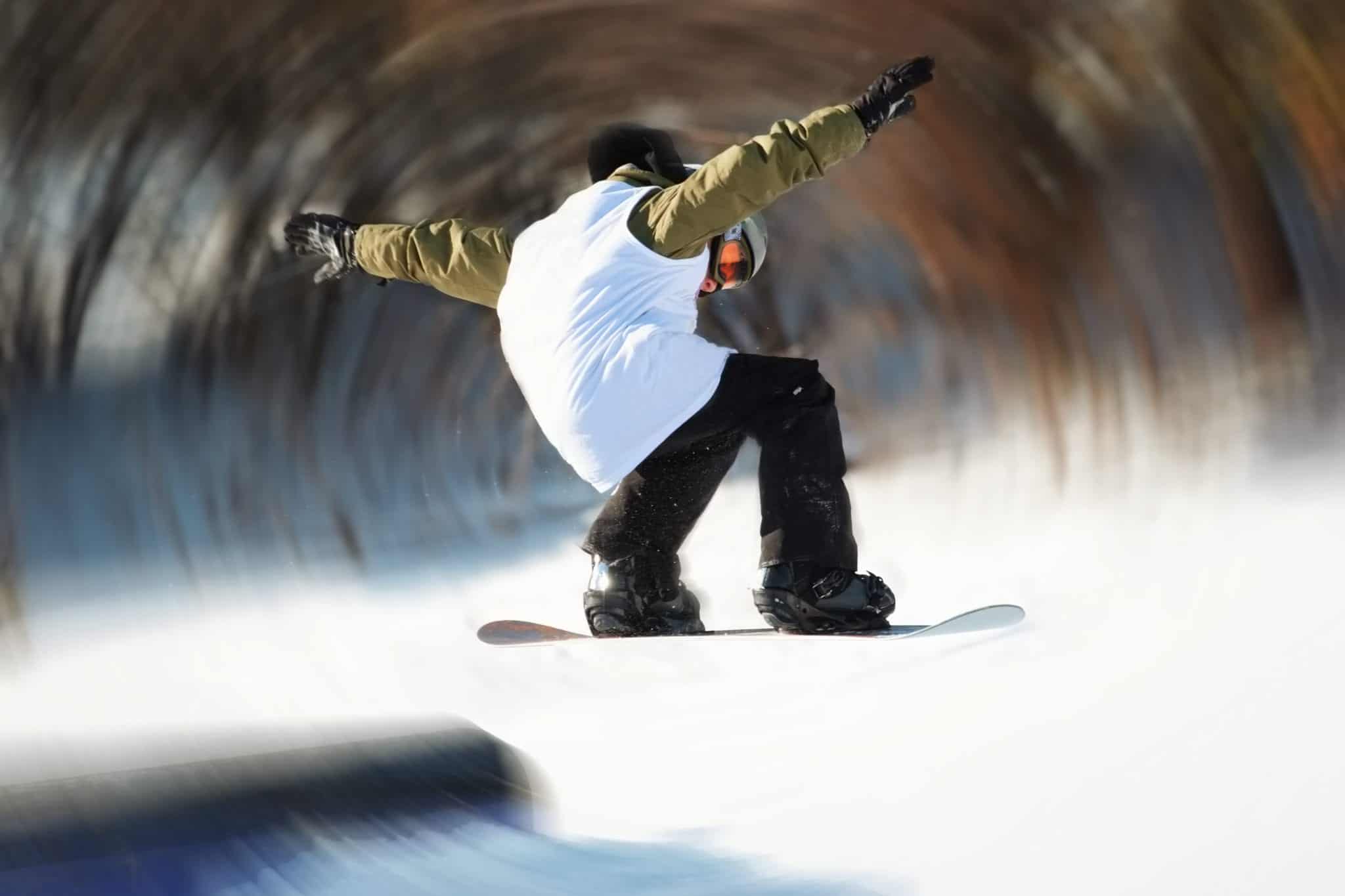 Snowboarder making a jump with arms wide