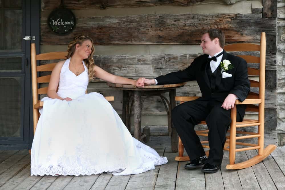 bride and groom sitting in rocking chairs on the deck of a Gatlinburg cabin