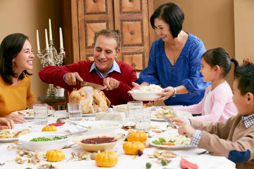 happy family enjoying Thanksgiving dinner in a Gatlinburg cabin
