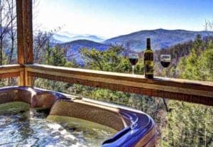 wine next to hot tub on the deck of a Gatlinburg cabin rental