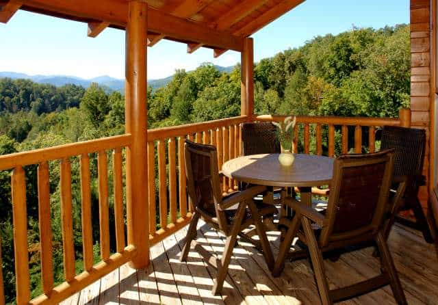 table and chairs on the deck of a mountain cabin in Gatlinburg TN