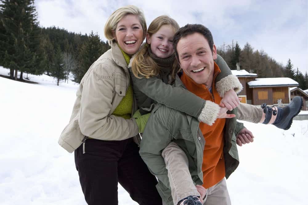 a family laughing in the snow in Gatlinburg