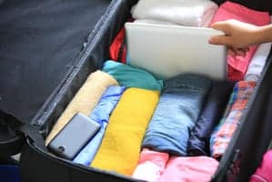 person packing a suitcase