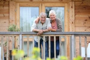older couple on the deck of a cabin