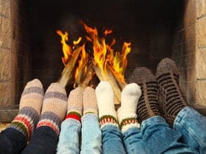 a family warming feet by the fire
