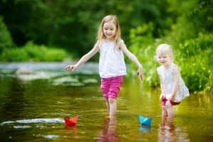 little girls playing in a river