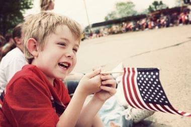 little boy holding a flag