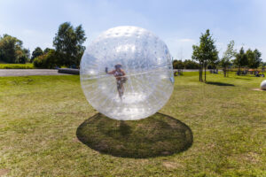 person playing in a zorb at outdoor gravity park in pigeon forge